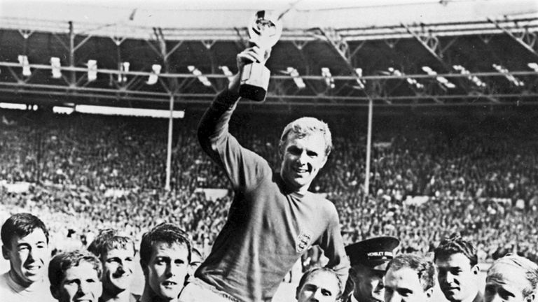 Bobby Moore holds aloft the Jules Rimet trophy as he is carried by his teammates following England's victory over Germany (4-2 in extra time) in the World Cup final on July 30 1966 