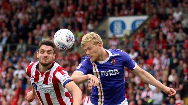 Exeter City&#39;s Jayden Stockley (right) and Lincoln City&#39;s Luke Waterfall battle for the ball