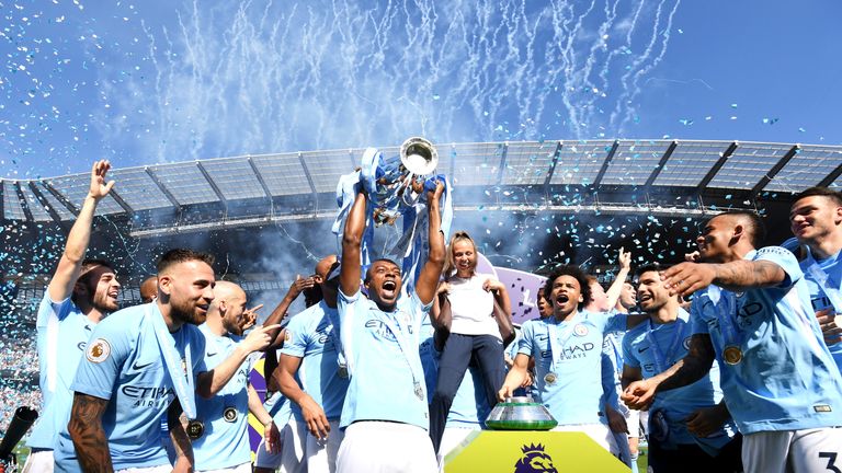 Fernandinho lifts the Premier League trophy after Manchester City are crowned Premier League champions at the Etihad Stadium
