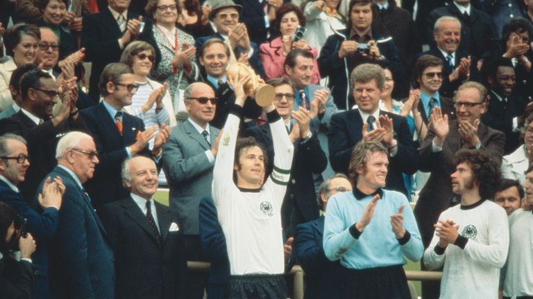 Franz Beckenbauer (centre) of Germany becomes the first Captain to lift the new FIFA trophy after leading his side to victory over Holland in the World Cup Final at the Olympic Stadium in Munich