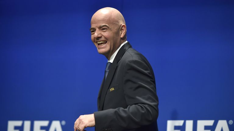  President Gianni Infantino smiles while leaving a press briefing