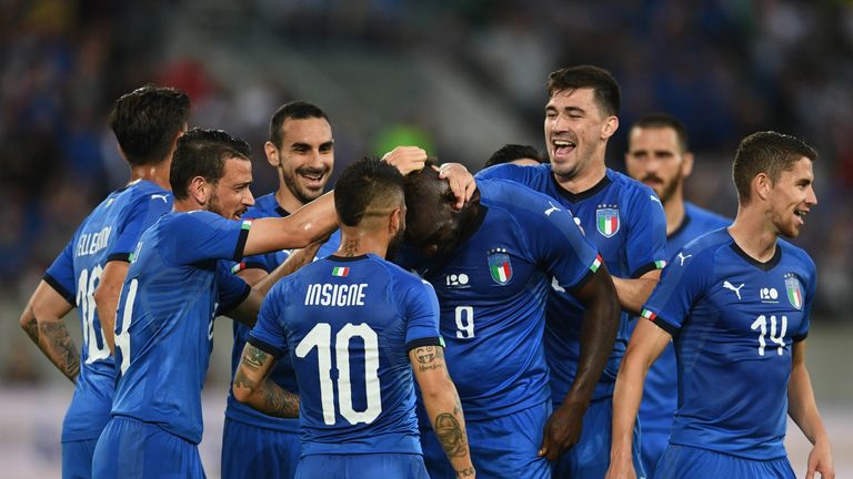Mario Balotelli is congratulated by his team-mates after scoring the opening goal for Italy against Saudi Arabia