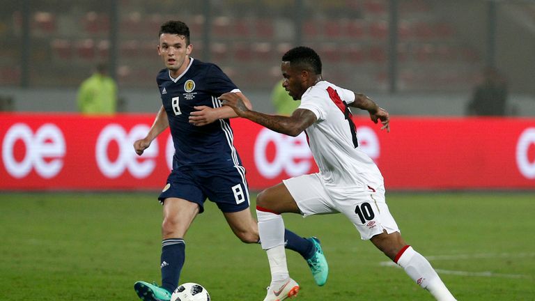 Jefferson Farfan of Peru fights for the ball against John McGinn of Scotland during the international friendly match