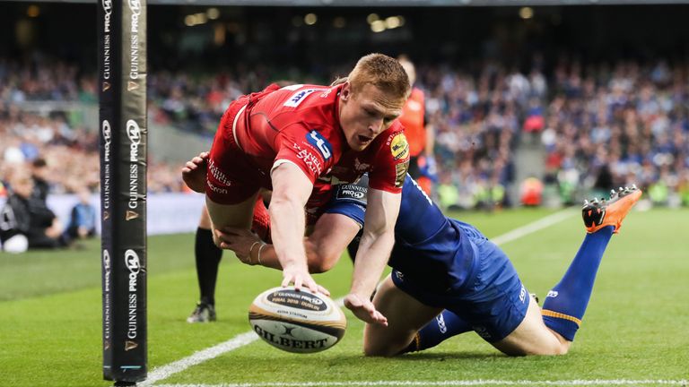 Johnny McNicholl scores a try despite the efforts of Garry Ringrose 