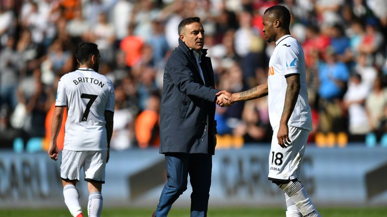 Jordan Ayew and Carlos Carvalhal shake hands at the final whistle as Swansea City are relegated