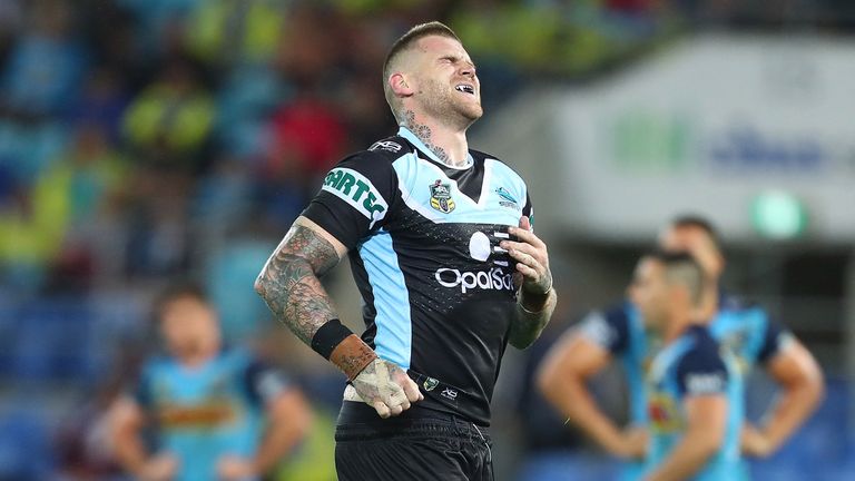 Josh Dugan of the Sharks leaves the field injured during the round eight NRL match between the Gold Coast Titans and Cronulla Sharks