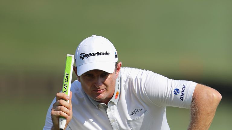 Justin Rose of England sizes up a putt during the first round of The Players Championship