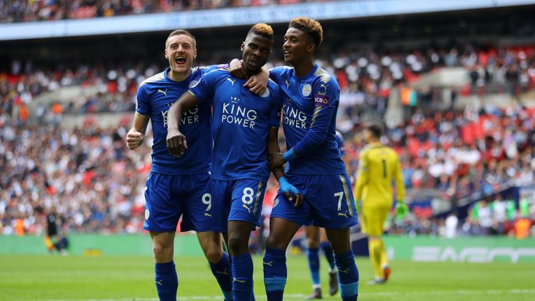 Kelechi Iheanacho celebrates with Jamie Vardy and Demarai Gray after scoring Leicester's third