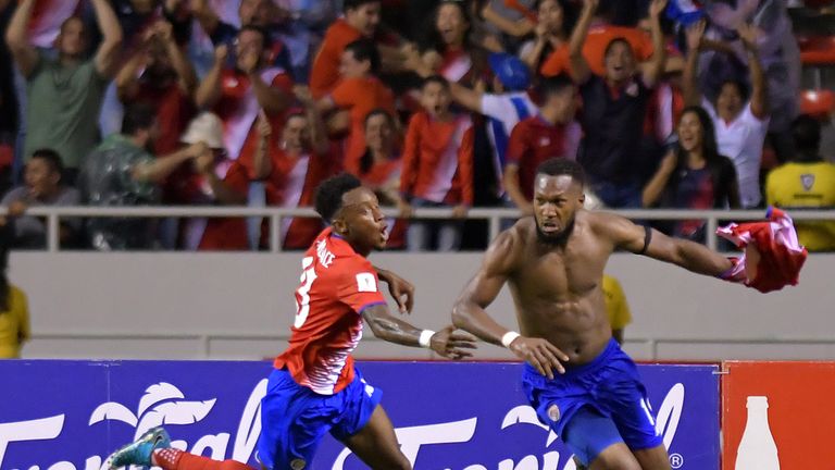 Costa Rica's Kendall Waston (R) celebrates Costa Rica's Rodney Wallace after scoring against Honduras during their 2018 World Cup qualifier football match, in San Jose on October 7