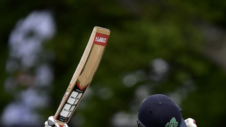 Kevin O'Brien of Ireland celebrates scoring a test century during the fourth day of the international test cricket match between Ireland and Pakistan