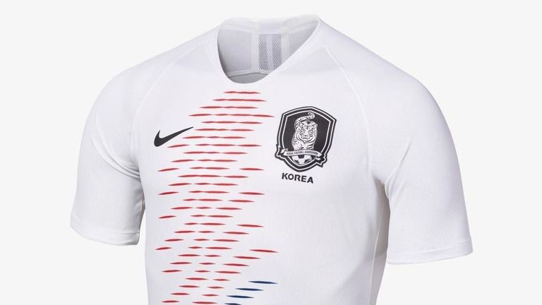 South Korea's away strip includes a red and blue pattern running down the front