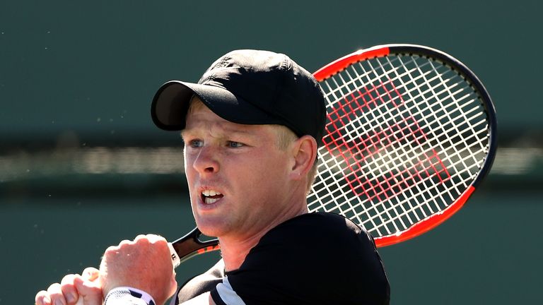 Kyle Edmund of Great Britain returns a shot to Dudi Sela of Israel during the BNP Paribas Open at the Indian Wells Tennis Garden on March 11, 2018 in Indian Wells, California