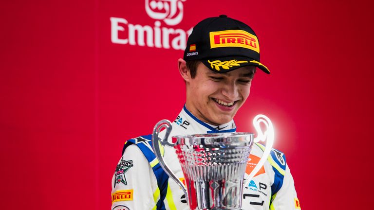 Lando Norris celebrates on the podium