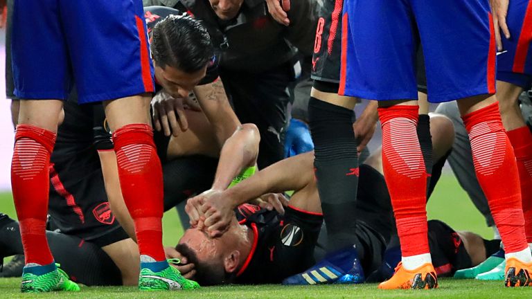 Arsenal's Laurent Koscielny receives medical attention at the Wanda Metropolitano