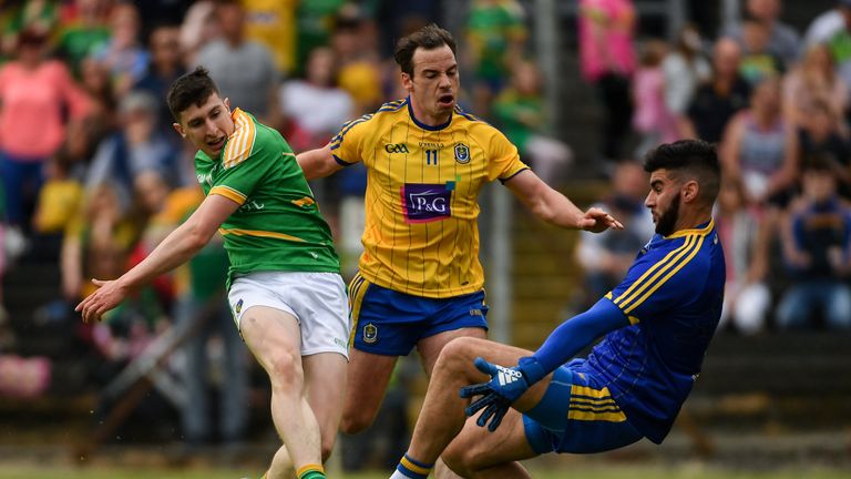 Jack Heslin of Leitrim has his shot on goal saved by Roscommon goalkeeper Colm Lavin as Niall Kilroy of Roscommon.