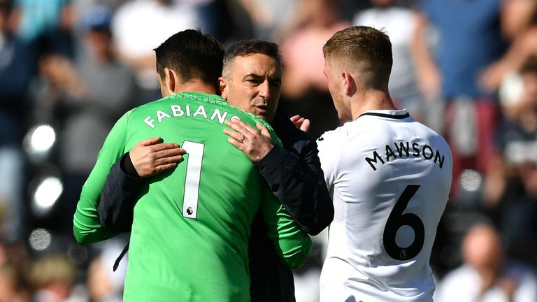 Lukasz Fabianski is embraced by Carlos Carvalhal as Swansea City are relegated from the Premier League