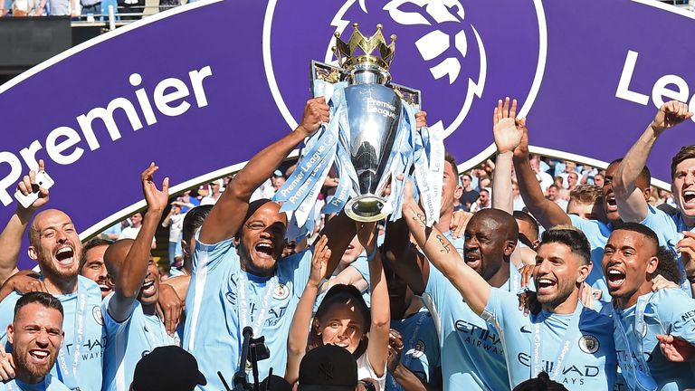 Vincent Kompany and Yaya Toure lift the Premier League trophy after Manchester City's 0-0 draw with Huddersfield Town