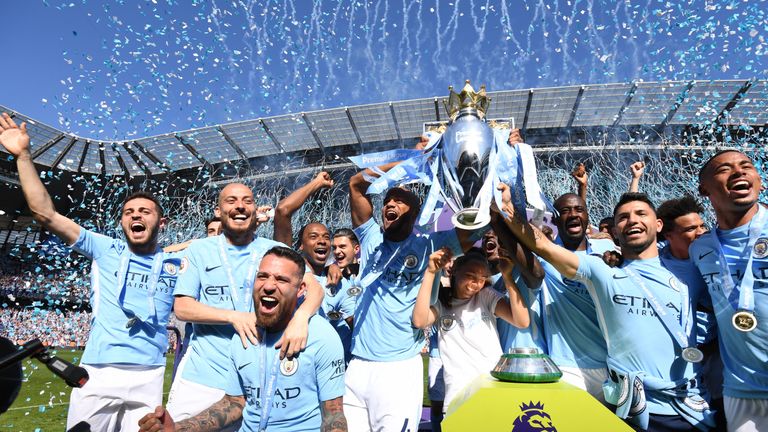 Manchester City players lift the Premier League trophy after being crowned champions at Etihad Stadium
