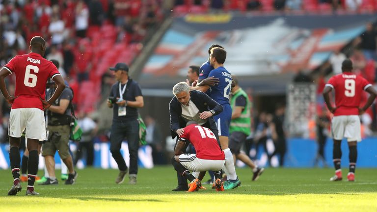 Manchester United manager Jose Mourinho consoles Ashley Young after the FA Cup final defeat to Chelsea