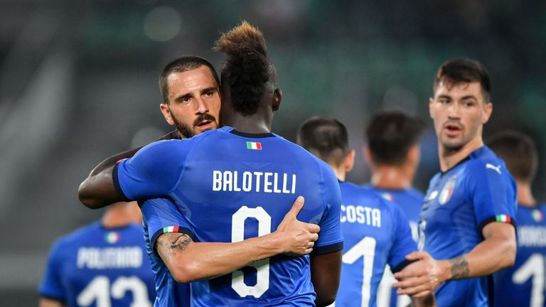 Italy's forward Mario Balotelli (C) is congratulated by Italy's defender Leonardo Bonucci (L) after scoring his team's first goal during the friendly football match between Italy and Saudi Arabia at Kybunpark stadium in St Gallen