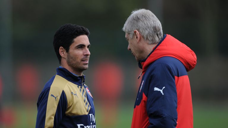 Mikel Arteta (left) speaks to Arsene Wenger