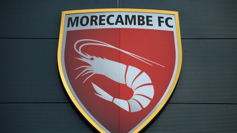 MORECAMBE, ENGLAND - OCTOBER 19: xxxx of Morecambe tackles xxxx of AFC Wimbledon during the Sky Bet League Two match between Morecambe and AFC Wimbledon at Globe Arena on October 19, 2013 in Morecambe, England, (Photo by Tony Marshall/Getty Images)