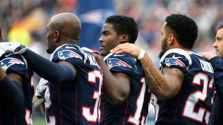 Members of the New England Patriots stand during the National Anthem before a game against the Los Angeles Chargers at Gillette Stadium on October 29, 2017 in Foxboro, Massachusetts.  (Photo by Jim Rogash/Getty Images)