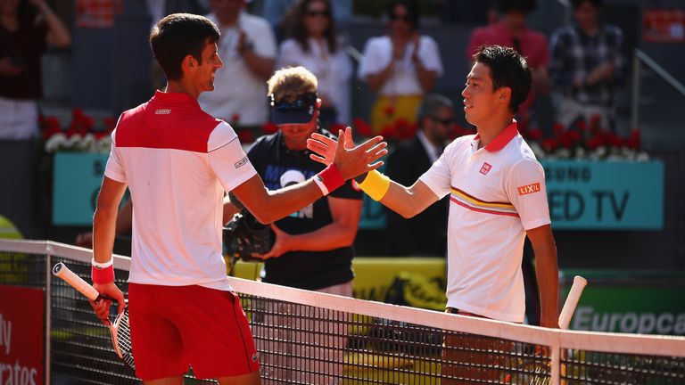 Novak Djokovic of Serbia shakes hands at the net after his straight sets victory against Kei Nishikori of Japan in their first round match during day three of the Mutua Madrid Open tennis tournament at the Caja Magica on May 7, 2018 in Madrid, Spain.