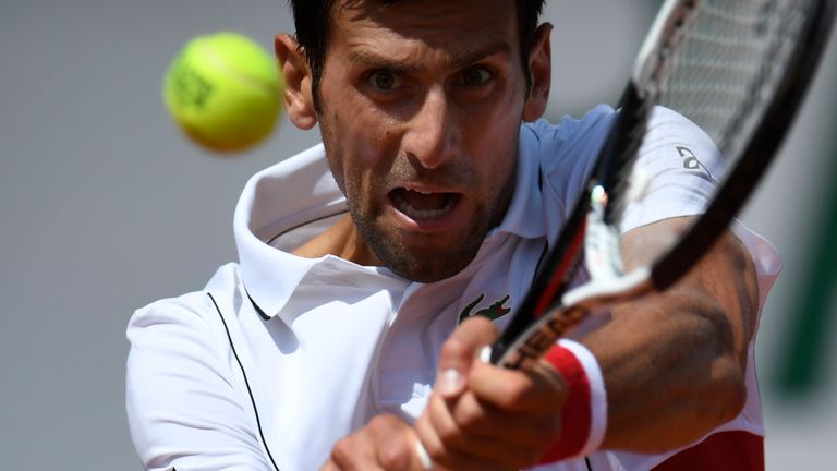 Serbia's Novak Djokovic plays a backhand return to Spain's Jaume Munar during their men's singles second round match on day four of The Roland Garros 2018 French Open tennis tournament in Paris on May 30, 2018.