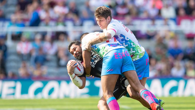 Widnes's Patrick Ah Van is tackled by St Helens' Zeb Taia & Louie McCarthy-Scarsbrook.