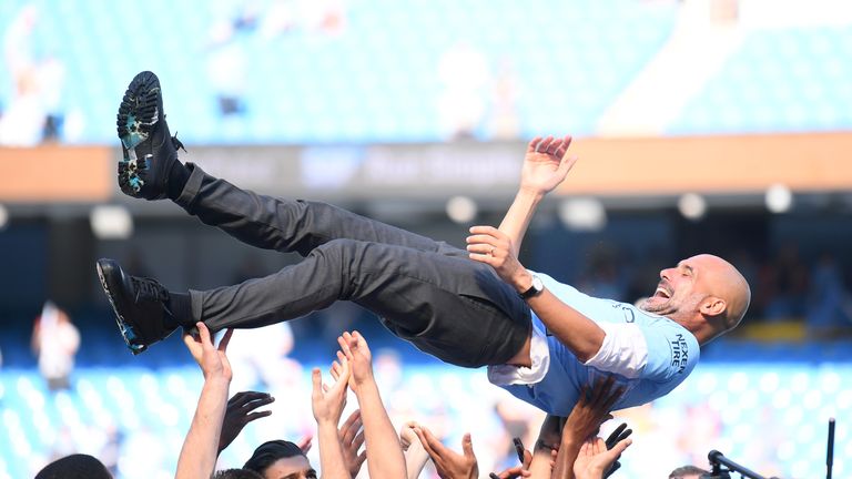 Pep Guardiola is thrown into the air by his players during celebrations after Manchester City are crowned Premier League champions