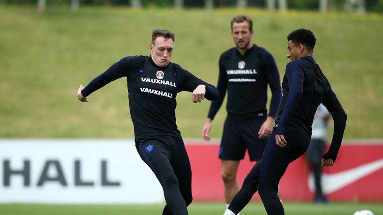 Phil Jones goes in for a challenge with Manchester United team-mate Jesse Lingard during an England training session at St Georges Park