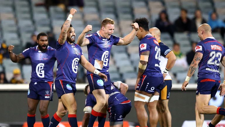 Reece Hodge of the Rebels celebrates with team mates 