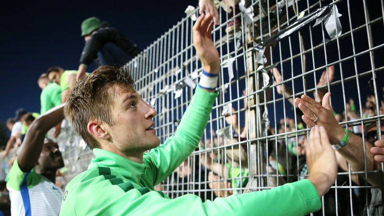 Robin Knoche celebrates Wolfsburg's relegation play-off win with fans