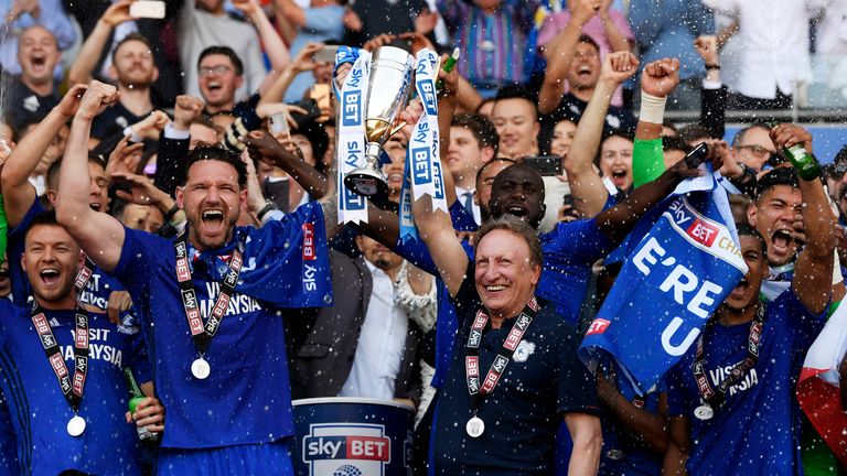Cardiff City's Sean Morrison lifts the Sky Bet Championship trophy with Neil Warnock as they celebrate gaining promotion to the Premier League