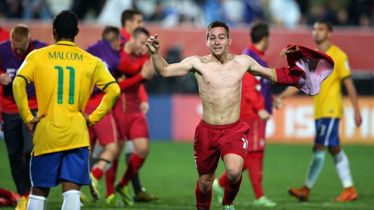 Serbia's Andrija Zivkovic (R) celebrates after the FIFA Under-20 World Cup football final match between Brazil and Serbia in Auckland on June 20, 2015.  AFP PHOTO / Michael Bradley (Photo credit should read MICHAEL BRADLEY/AFP/Getty Images)
