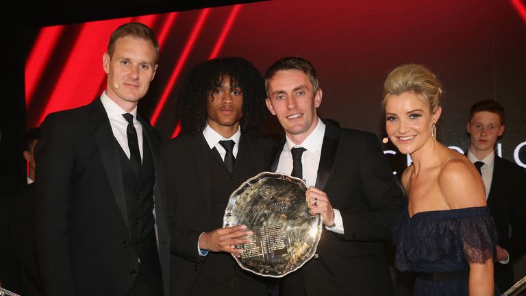 Tahith Chong is presented with the Jimmy Murphy Under-18s Player of the Season award by U18s manager Kieran McKenna