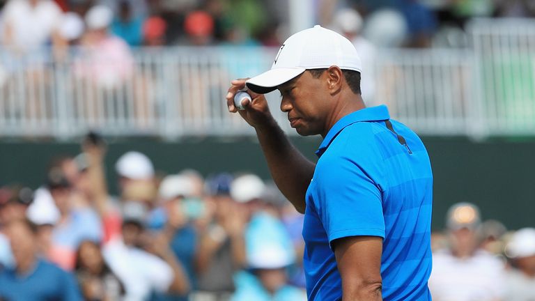 Tiger Woods reacts to his eagle at the ninth during the first round of The Players Championship