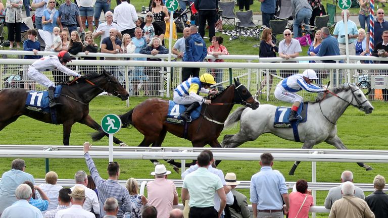 Thundering Blue (right) ridden by jockey Andrea Atzeni goes on to win the Equinity Technology Handicap at York