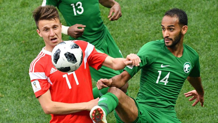 Aleksandr Golovin and Abdullah Otayf in action during the opening match of the 2018 World Cup