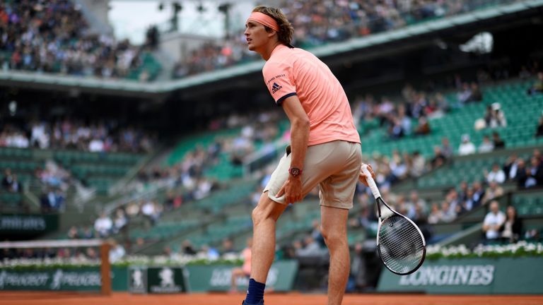 Germany's Alexander Zverev holds his thigh after a point, during his men's singles quarter-final match against Austria's Dominic Thiem on day ten of The Roland Garros 2018 French Open tennis tournament in Paris on June 5, 2018.