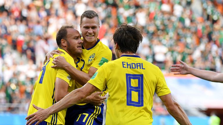 Andreas Granqvist celebrates with Viktor Claesson and Albin Ekdal after doubling Sweden's lead