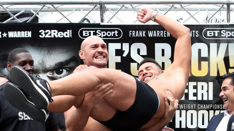 Tyson Fury lifts opponent Sefer Seferi during the weigh-in