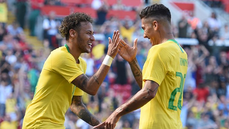 Brazil's Neymar celebrates his goal-scoring return to action against Croatia with Roberto Firmino