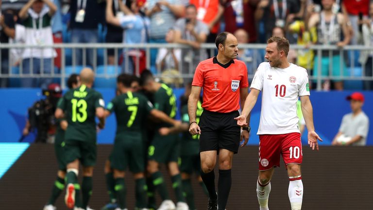Christian Eriksen protests the decision to award Australia a penalty to referee Antonio Mateu