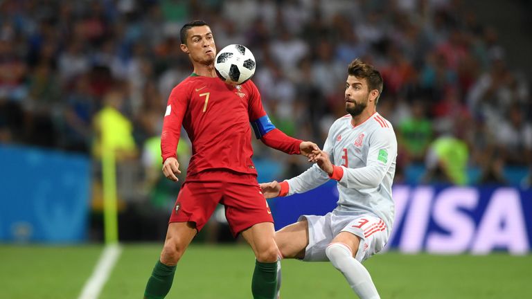 Cristiano Ronaldo of Portugal is challenged by Gerard Pique of Spain during the 2018 FIFA World Cup Russia group B match between Portugal and Spain at Fisht Stadium on June 15, 2018 in Sochi, Russia.