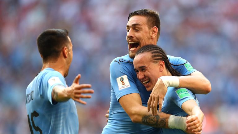 Diego Laxalt  celebrates with team-mates after scoring Uruguay's second