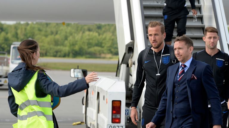 England's striker Harry Kane (3R) and teammates arrive at Saint Petersburg's Pulkovo airport on June 12, 2018, to take part in the 2018 FIFA World Cup football tournament in Russia. (Photo by OLGA MALTSEVA / AFP)