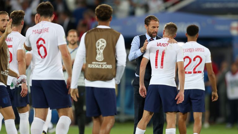 England boss Gareth Southgate consoles Jamie Vardy after the 1--0 defeat to Belgium 