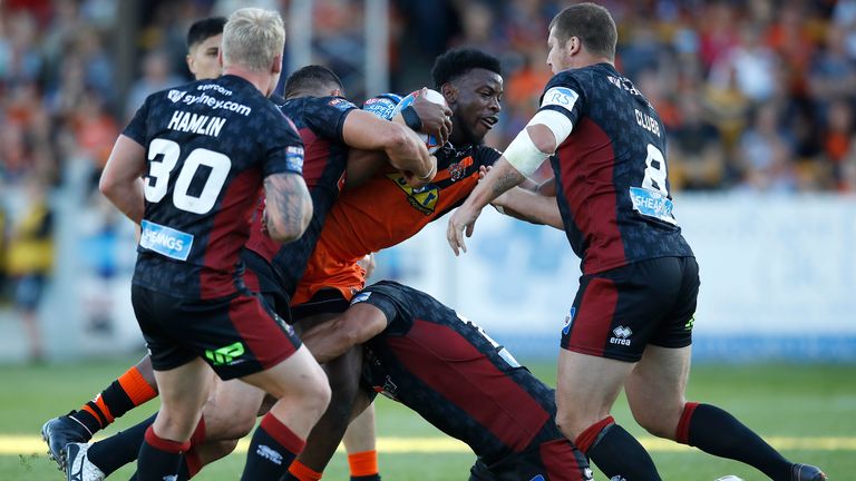 Castleford Tigers Gadwin Springer is tackled by Wigan Warriors Taulima Tautai and Tony Clubb 